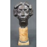 PATINATED HOLLOW CAST BRONZE HEAD OF A WOMAN on alabaster pedestal with square base,