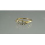 AN OLD CUT DIAMOND THREE STONE RING in scrolling engraved setting. ring size R, weight 4g approx.