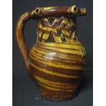 19TH CENTURY POTTERY TWO TONE BROWN GLAZED PUZZLE JUG having pierced neck and neck ring with five