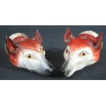 A PAIR OF ENGLISH PORCELAIN FOX HEAD STIRRUP CUPS, realistically modelled and painted,