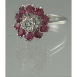 AN 18CT WHITE GOLD DIAMOND AND RUBY DRESS RING.