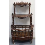 VICTORIAN WALNUT SERPENTINE FRONTED MUSIC STAND WHATNOT having pierced and scrolled mounts,