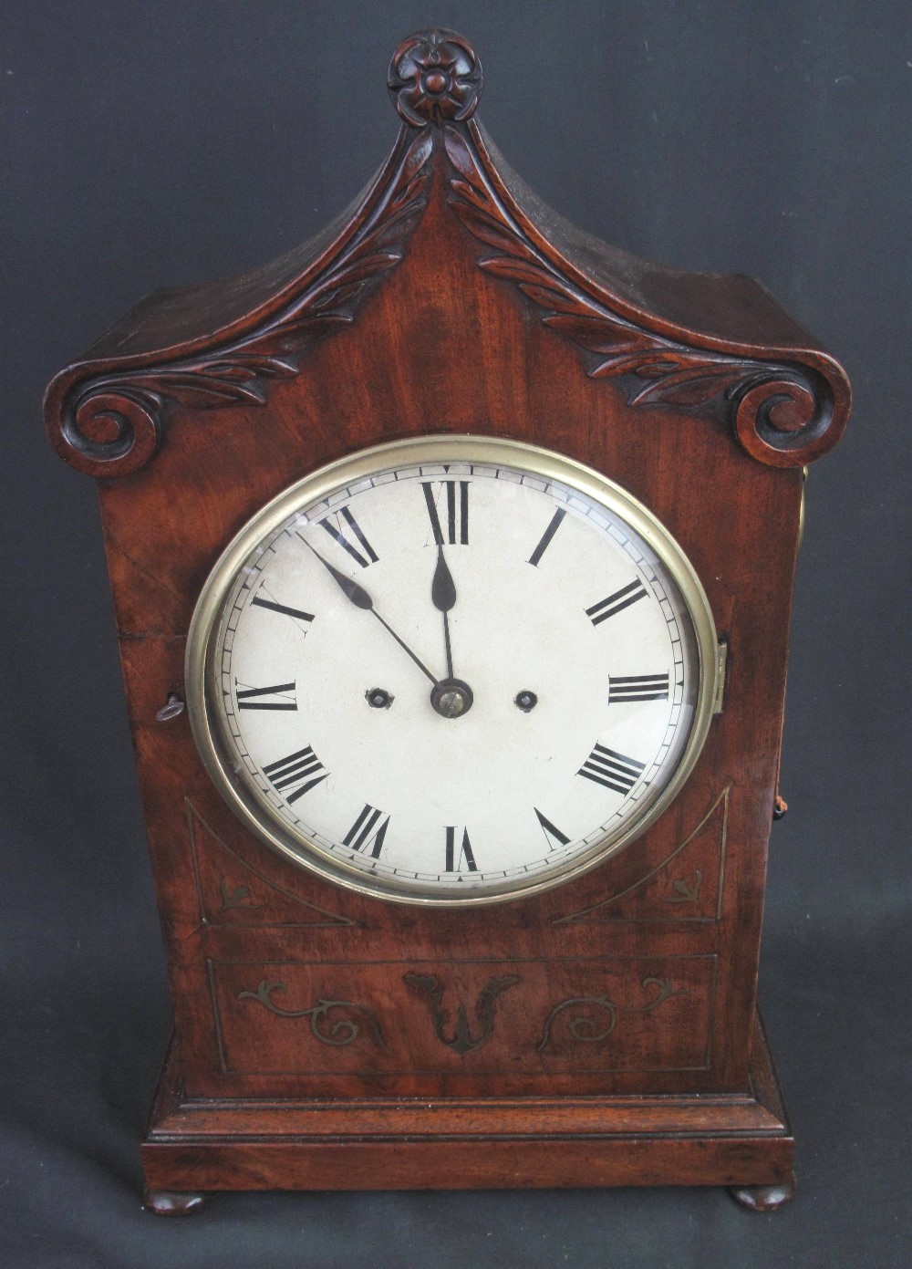 EARLY 19TH CENTURY MAHOGANY BRACKET CLOCK having scroll and foliate moulded pointed arch top over