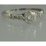 A PLATINUM AND DIAMOND SOLITAIRE RING. The brilliant cut diamond an estimated 0.