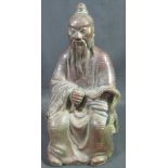 CHINESE HOLLOW BRONZE FIGURE OF AN ELDERLY IMMORTAL, seated and holding fly-whisk,