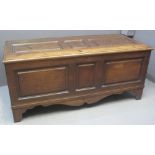 LARGE 18TH CENTURY OAK COFFER having panelled hinged top over three panel front over bracket feet