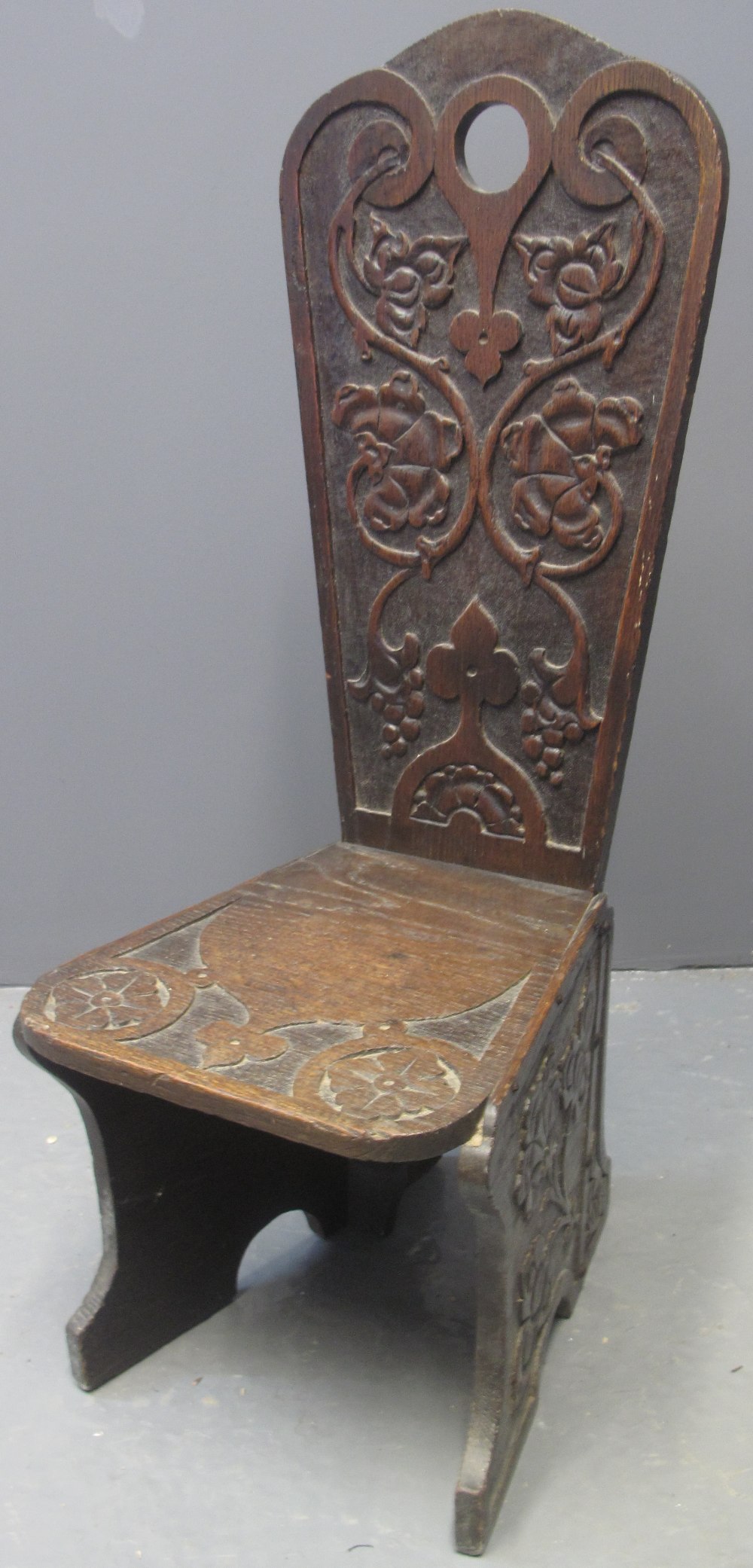 19TH CENTURY CARVED OAK GOTHIC DESIGN SPINNING CHAIR having tracery and flower head moulded