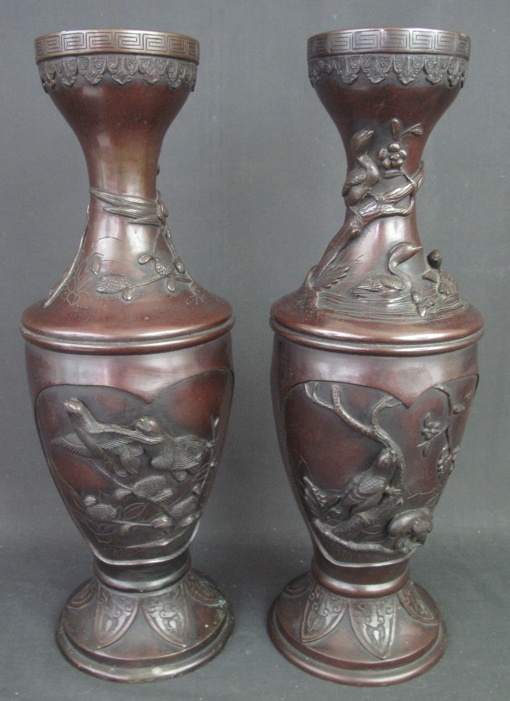 PAIR OF MEIJI PERIOD JAPANESE BRONZE VASES overall with reserve relief panels depicting birds