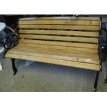 Garden bench with oak slats and pierced cast iron bench ends. (B.P. 24% incl.