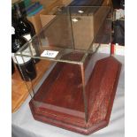 Glass rectangular case on mahogany octagonal stand. (B.P. 24% incl.