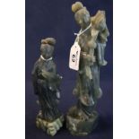 Two Chinese hardstone figures of Guanyin, the larger figure holding a lotus flower,
