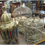 Two metal bird cages, together with Middle Eastern design brass and multi-coloured glass lantern.