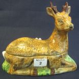 French fiaence pottery bowl and cover in the form of a recumbent fawn.