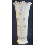 Belleek porcelain flared cylinder vase with waved neck, decorated in relief shamrocks and foliage.