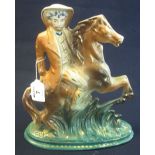 20th Century flat backed pottery figure of a gentleman on rearing horse. 31cm high approx. (B.P.