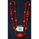 Long Art Deco string of simulated red amber beads. (B.P. 24% incl.