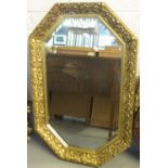 Modern gilt framed bevel plate octagonal mirror with relief foliate decoration. (B.P. 24% incl.