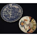 Two Japanese porcelain fluted dishes the larger with blue and white decoration fantastic birds