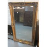 Large gilt and foliate framed bevel plate rectangular mirror. (B.P. 24% incl.