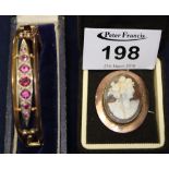 9ct gold shell cameo brooch and a 9ct gold gem set bangle (broken). (B.P. 24% incl.