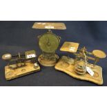 Two sets of brass postal scales on wooden bases,