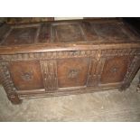 18th Century oak coffer having three moulded panels with Tudor rose type decoration.