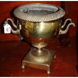 Brass pedestal two handled urn with gadroon decoration. (B.P. 24% incl.