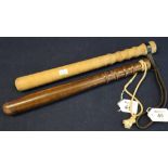 Two turned wooden truncheons, one with leather wrist thong. (2) (B.P. 24% incl.