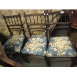 Set of three stained spindle back upholstered chairs on ring turned legs,