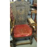 18th Century style carved and stained oak wainscot type armchair with foliate panelled back under