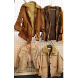 Two vintage fur jackets, one brown and one cream,