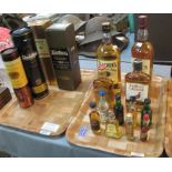 Two trays of various whiskies and other spirits to include; Bell's, Teacher's, Famous Grouse,