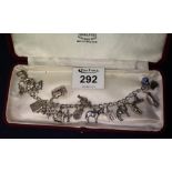 Silver charm bracelet with various charms. (B.P. 24% incl.