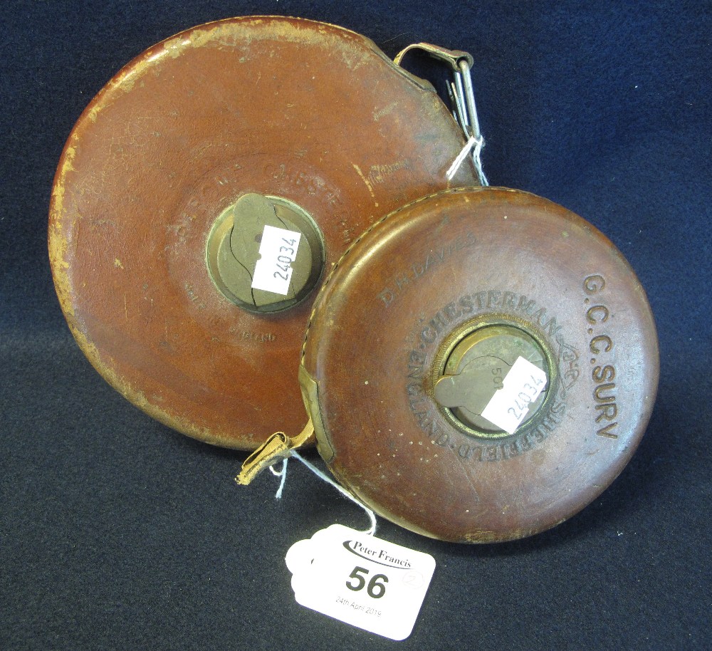 Two leather cased fabric tape measures. (2) (B.P. 24% incl.