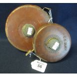 Two leather cased fabric tape measures. (2) (B.P. 24% incl.