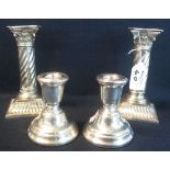 Pair of white metal corinthian column spiral twist candlesticks,