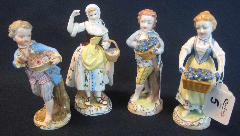 Set of four similar German porcelain juvenile street vendors, two boys, two girls.