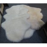 Box containing a sheepskin rug with John Wood label and two faux sheepskin rugs. (3) (B.P. 24% incl.