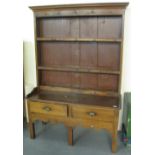 Early 19th century oak rack back dresser having two drawers with shaped apron standing on square