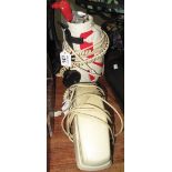 Novelty telephone in the form of golf bag and clubs, together with another cream telephone. (2) (B.
