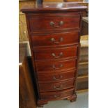 Reproduction mahogany finish narrow bowfront chest of seven drawers. (B.P. 24% incl.