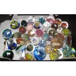 A collection of multi-coloured, art glass paper weights together with specimen hard stone eggs,