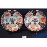Two similar Japanese Imari scallop edged dishes with floral panels and vase as centrefield.