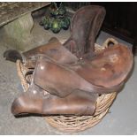 Equestrian saddle, some harness and a wicker work log basket. (B.P. 24% incl.