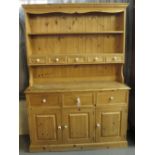 Modern pine dresser having fitted spice drawers with turned ceramic, blue and white handles. (B.P.