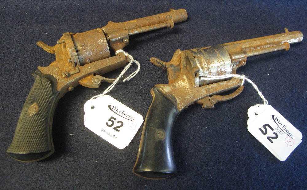 Two similar pin fire open frame revolvers with folding triggers.