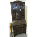 Early 20th Century carved oak two stage bureau bookcase with carved mask handles. (B.P. 24% incl.