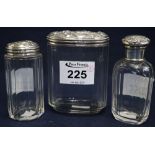 A collection of crystal glass dressing table jars with repousse silver tops. (3) (B.P. 24% incl.