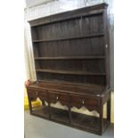 Late 18th Century Welsh oak potboard dresser having boarded three shelf rack over three moulded