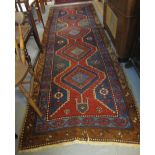 Middle Eastern geometric runner with flower head and lozenge field. (B.P. 24% incl.